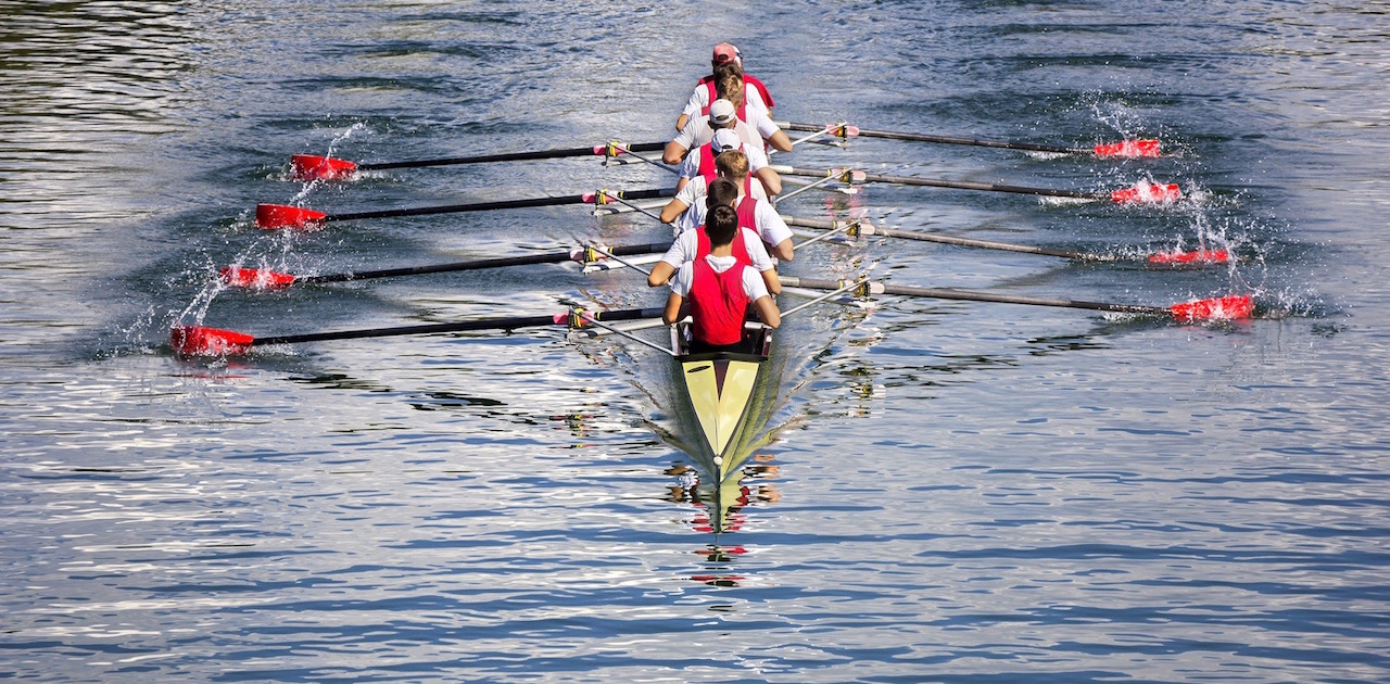 Rowers in eight-oar rowing boats on the tranquil lake